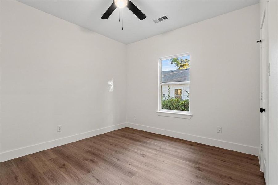 Spare room with light wood-type flooring and ceiling fan