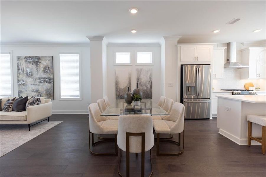 The Dining area greets you as you enter the main level. **Photos of model house and not of actual home - Photos for representation purposes only **