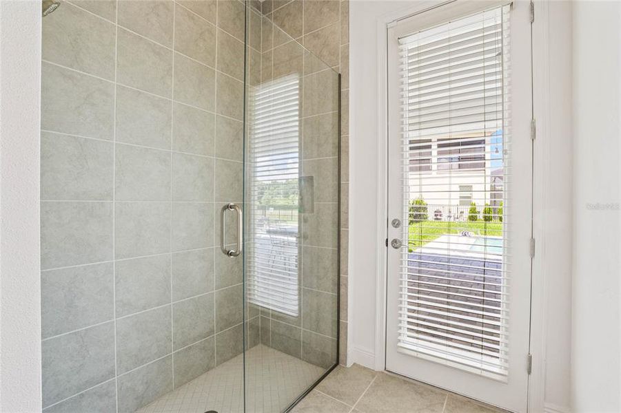 Bathroom with door leading to swimming pool area