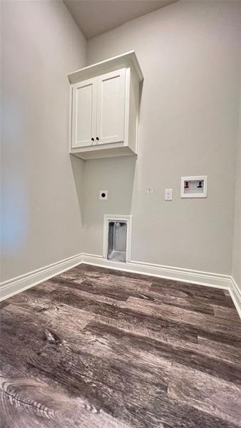 Laundry area featuring hookup for a washing machine, cabinets, hardwood / wood-style floors, and electric dryer hookup