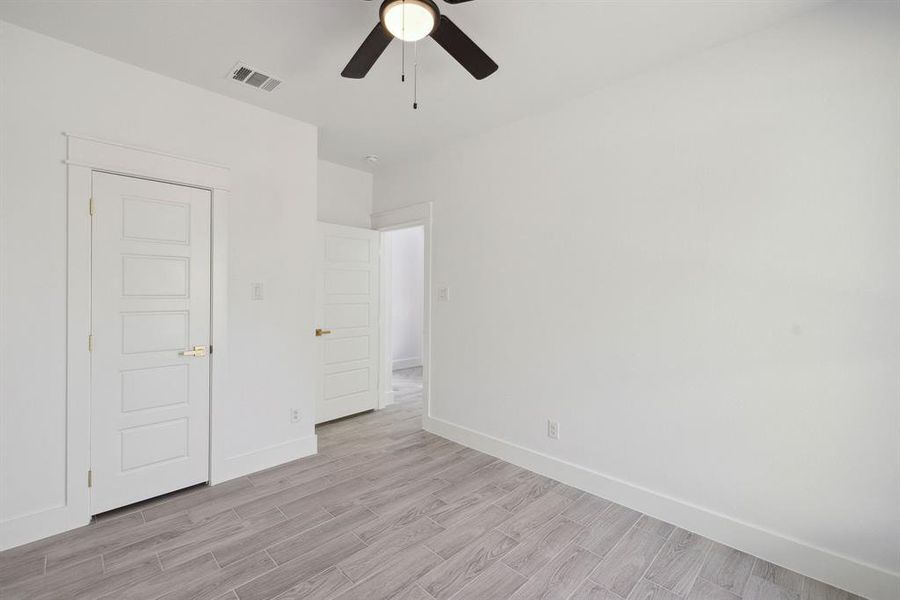 Spare room featuring light wood-type flooring and ceiling fan