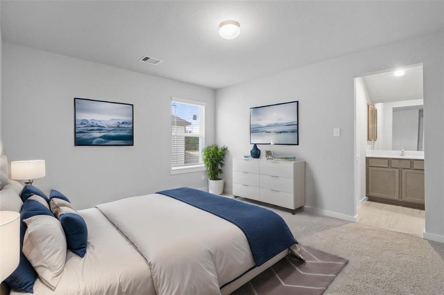 Secondary bedroom features plush carpet, custom paint, high ceilings, and a large window with privacy blinds. This secondary bedroom shares a jack-n-jill bathroom and access to its private vanity sink.