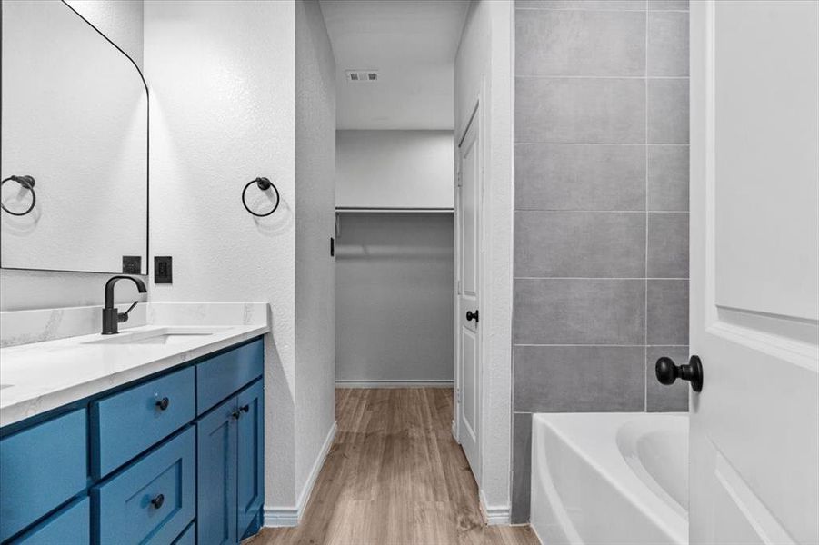 Bathroom with vanity and hardwood / wood-style floors