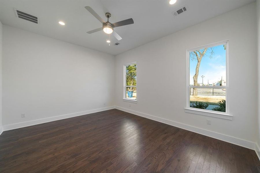 Empty room featuring hardwood / wood-style flooring and plenty of natural light