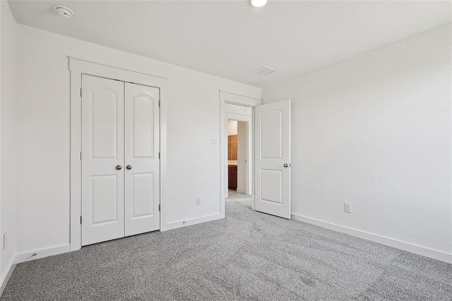 Unfurnished bedroom featuring a closet and carpet