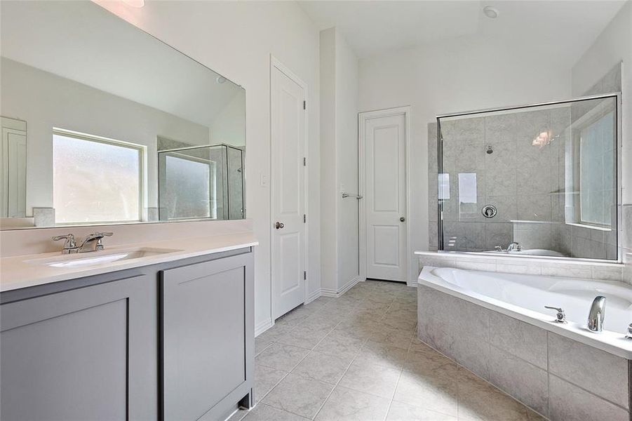 Bathroom featuring vanity, separate shower and tub, and tile patterned flooring