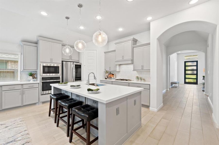 The spacious kitchen boasts a huge countertop, providing ample workspace for meal preparation and entertaining.