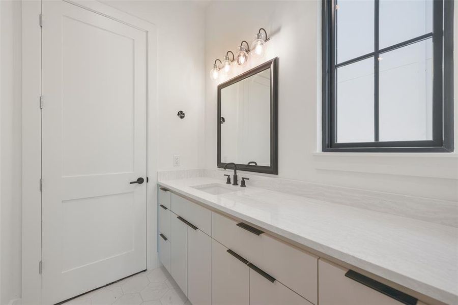 The secondary bath's are well appointed with decorative lighting, plumbing fixtures and abundant storage.