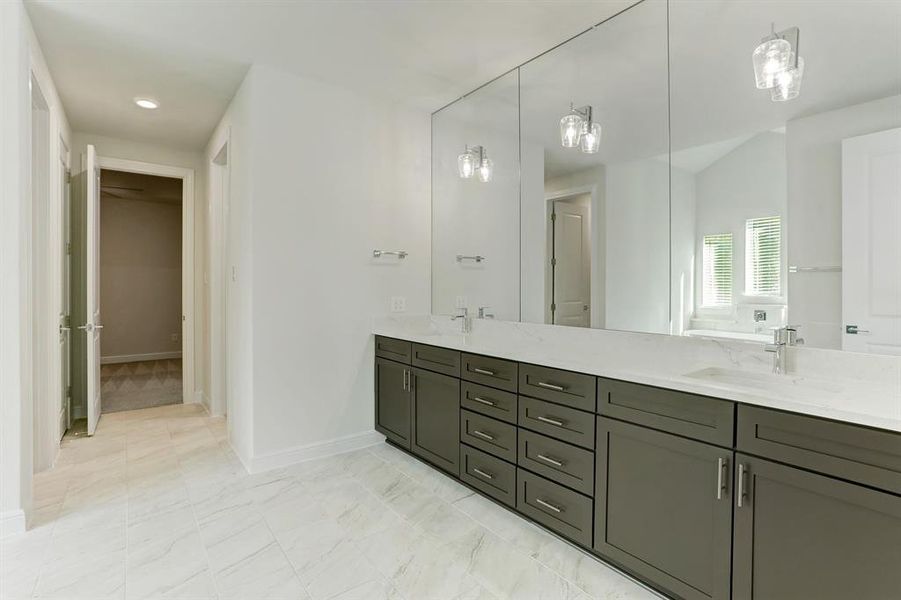 The owner bath of the Fairview has a gorgeous dual-sink vanity and full mirror that spans to the ceiling.