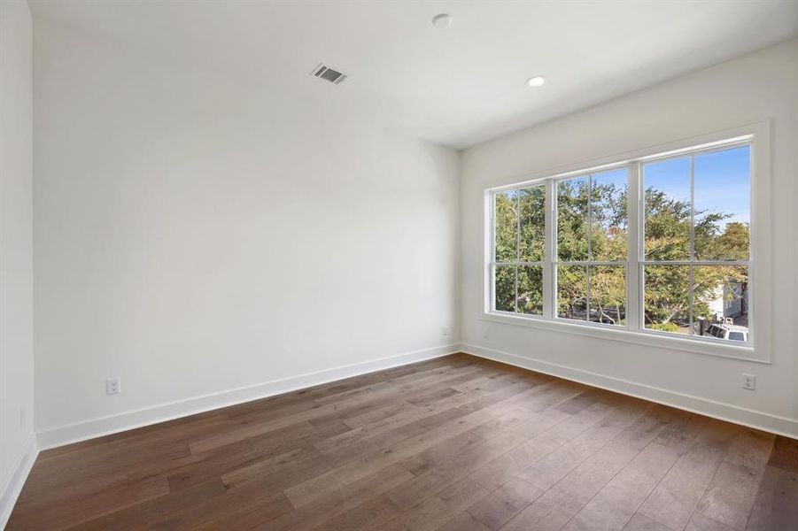 One of 3 upstairs secondary bedrooms each with fantastic closet, private ensuite bath and engineered white oak hardwood floors.