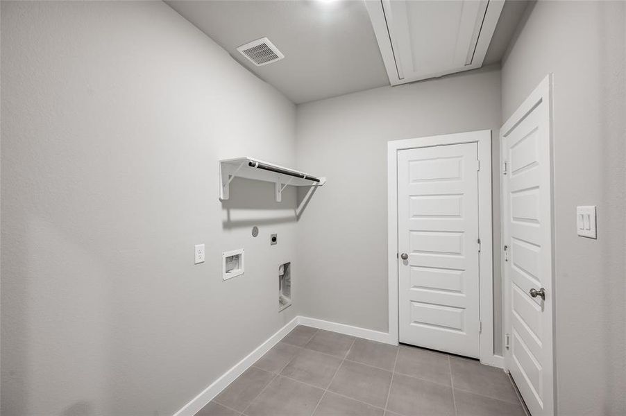 Large laundry room with access to the garage.