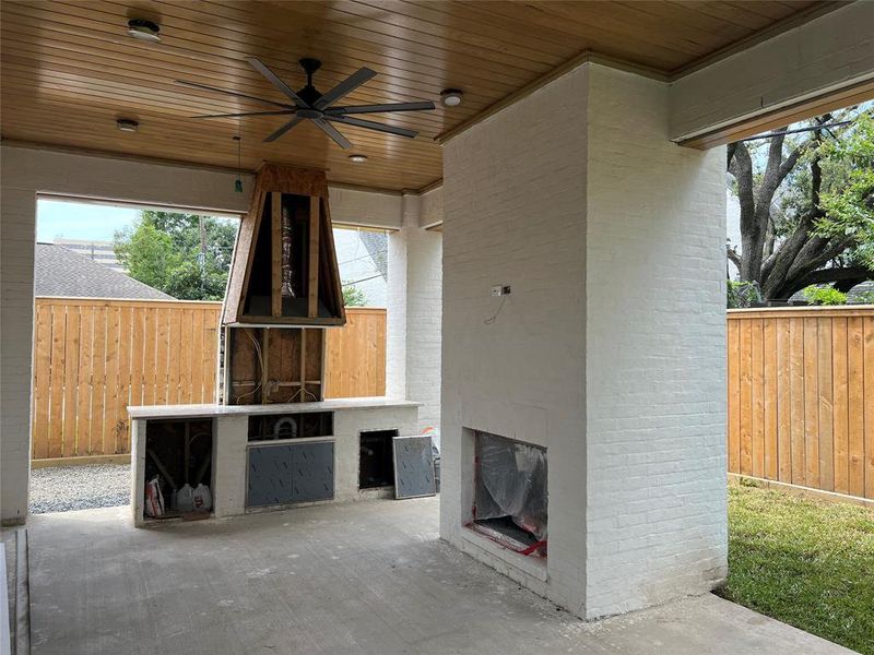 Back patio with wood burning fireplace and summer kitchen.