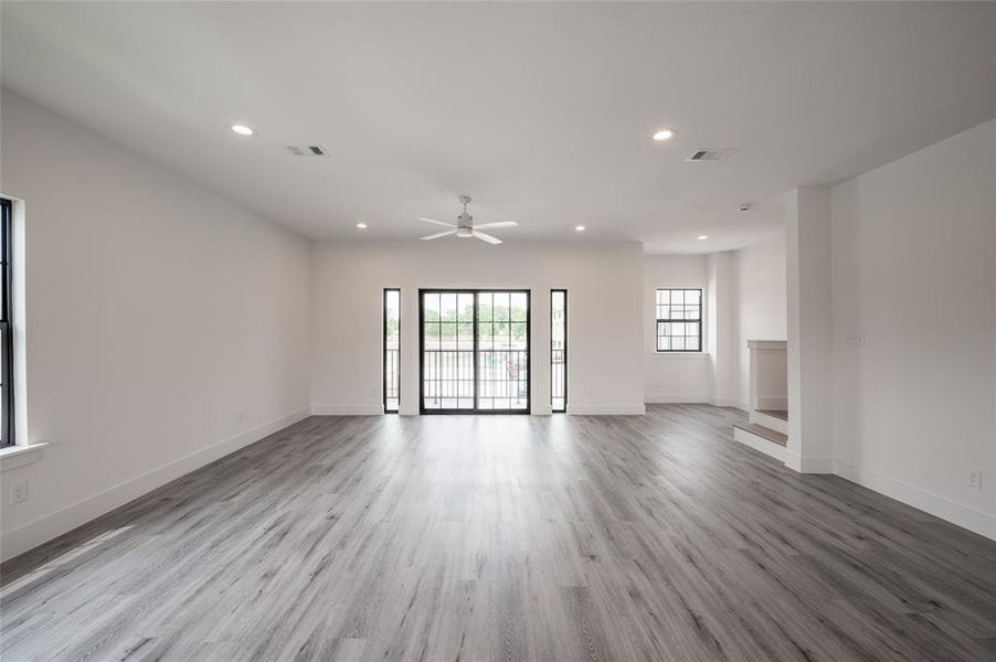 *Representative Photo. This is a spacious living area with sliding doors leading to an outdoor balcony.