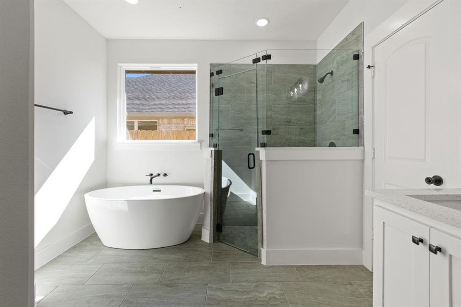 Bathroom featuring plus walk in shower and vanity