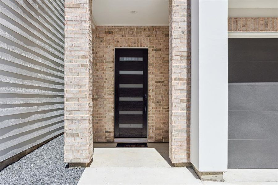 Sleek front door and spacious porch welcomes guests to your new home!