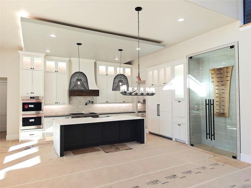 Your inner chef will revel in the high-end kitchen showcasing custom cabinets & range hood, 12’ ceilings, Wolf-Sub-Zero appliances & a generous island with seating for your whole family