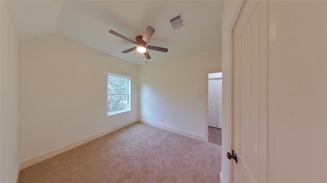 4209 Tampico St.Second bedroom with vaulted ceilings, a spacious closet and the laundry room across the hall.