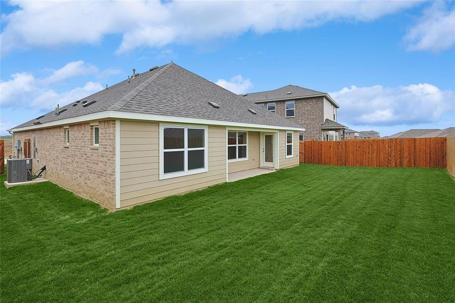 Back of property featuring a yard, a patio, and central air condition unit