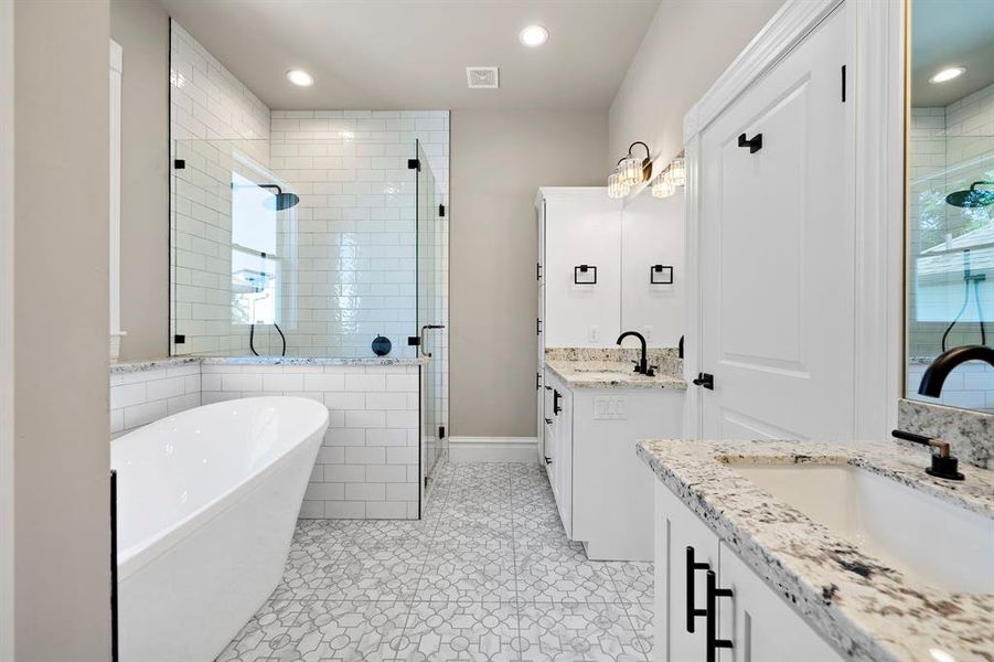 Primary bathroom - Shower in the corner. Custom cabinets and granite counters continue