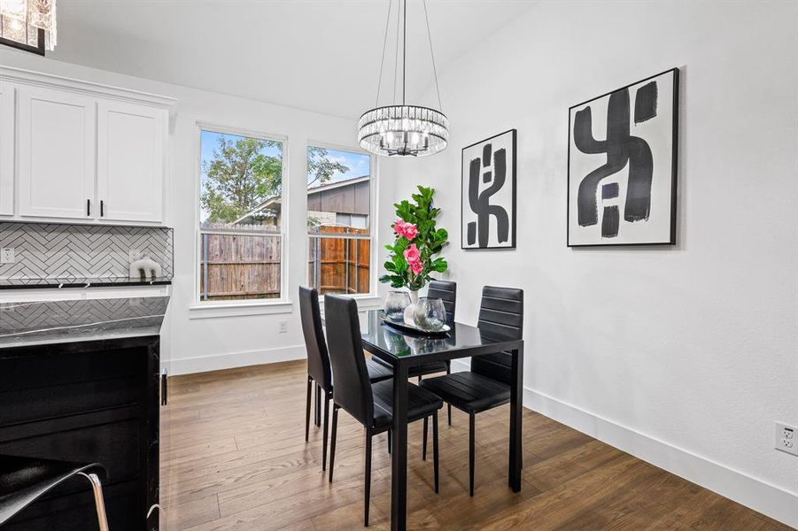 Dining area featuring dark wood-type flooring and a chandelier