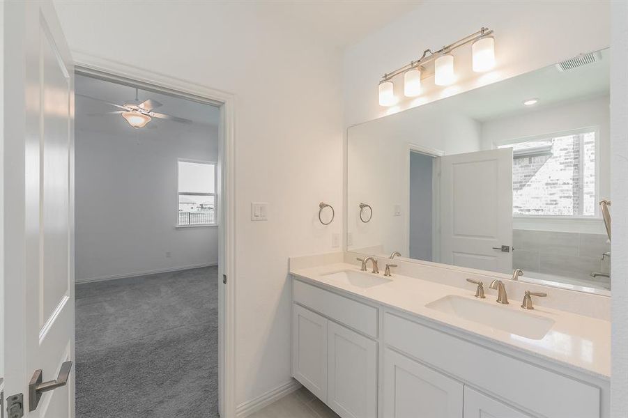 Bathroom with ceiling fan and vanity