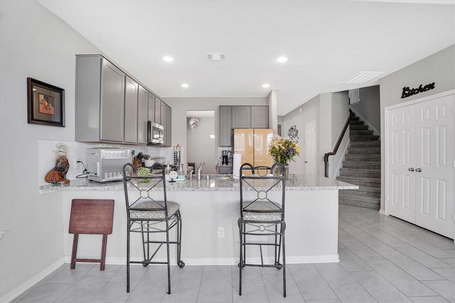 Spacious kitchen with expansive granite countertop.