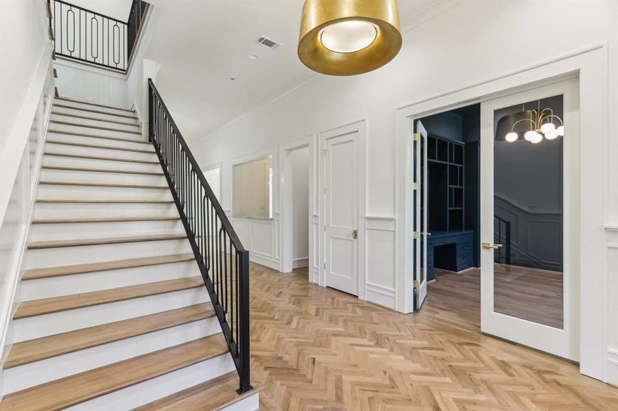 Welcome your guests in the main foyer, artfully composed with herringbone white oak floors & Visual Comfort Lighting.