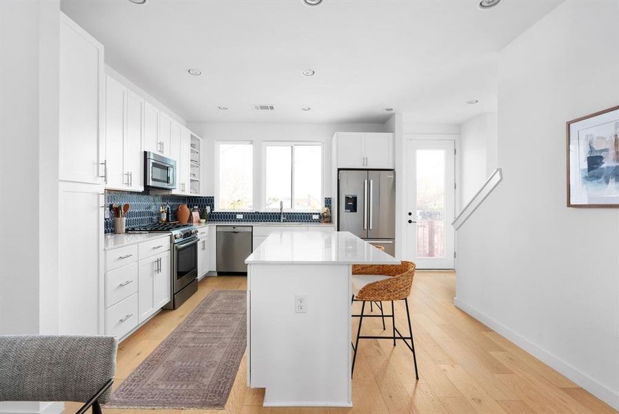 Long kitchen layout with ample storage and polished countertops for a seamless flow.