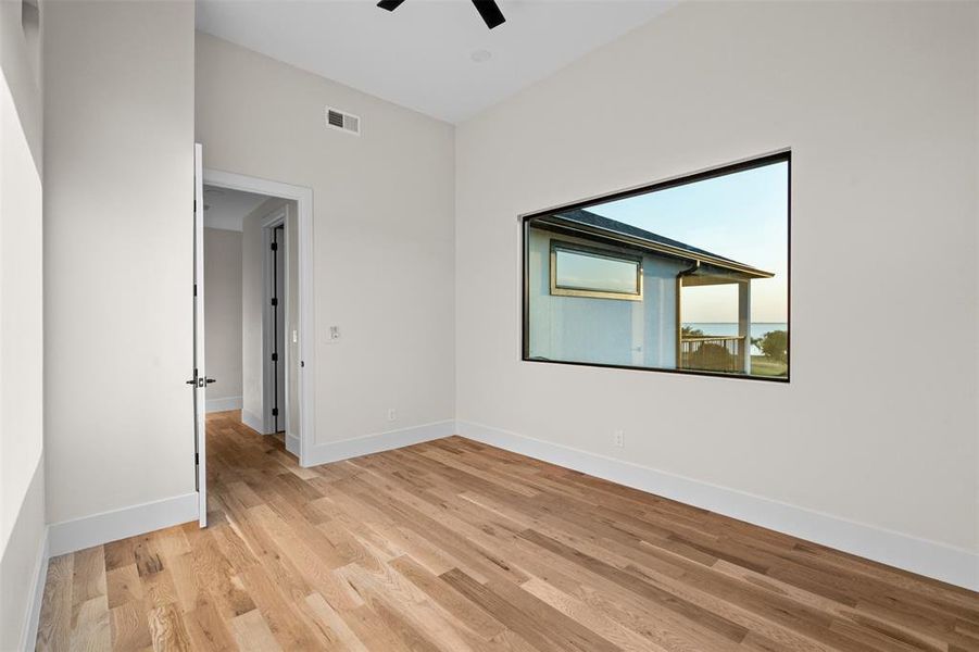 Unfurnished room featuring light wood-type flooring and ceiling fan