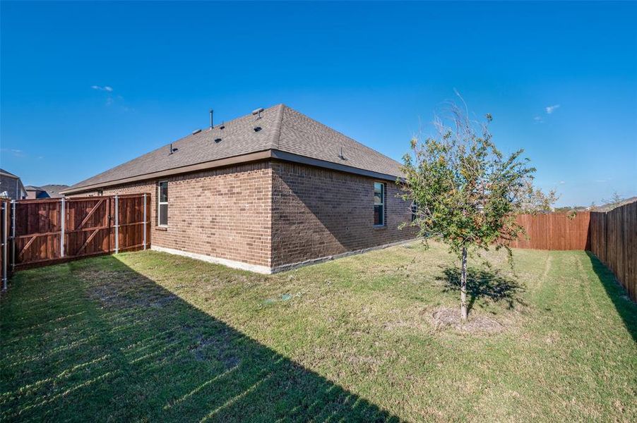 Rear view of house featuring a yard