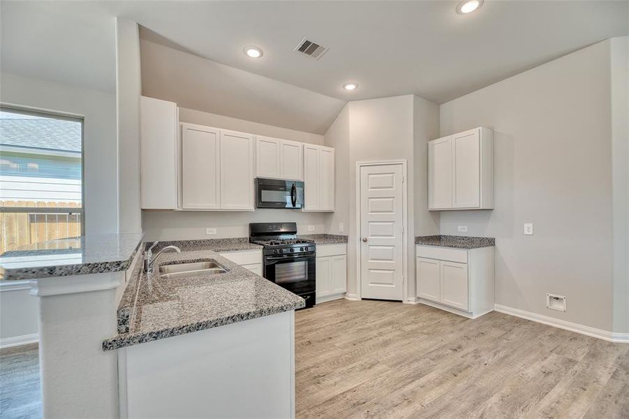 Adding to its functionality, a convenient walk-in pantry ensures ample storage space for pantry items and kitchen essentials. The kitchen is equipped with gas cooking facilities and a built-in microwave, providing versatile cooking options to suit your culinary needs.