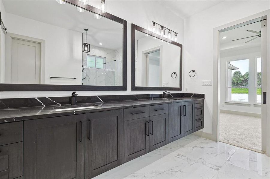 Bathroom with plenty of natural light, ceiling fan, vanity, and walk in shower