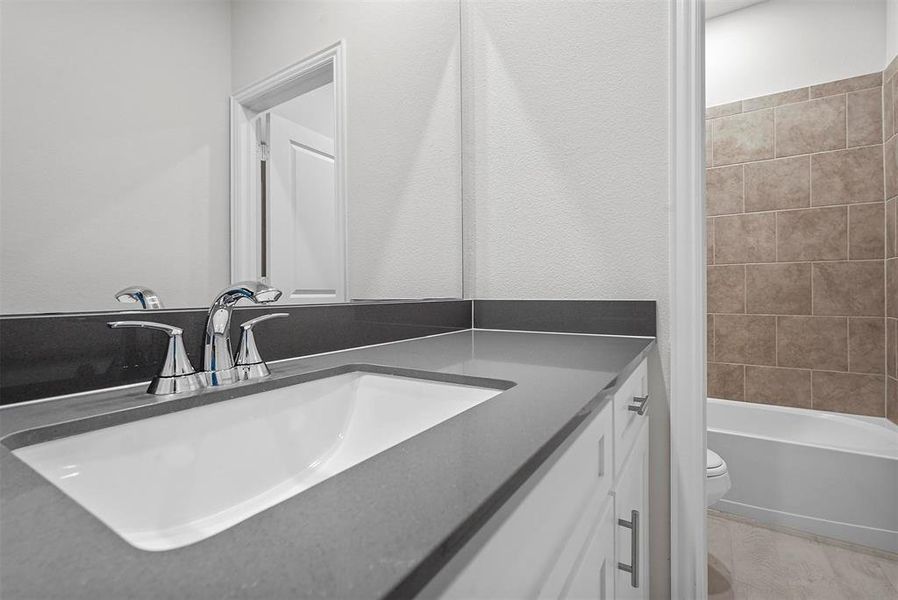 Full bathroom with shower / washtub combination, vanity, wood-type flooring, and toilet