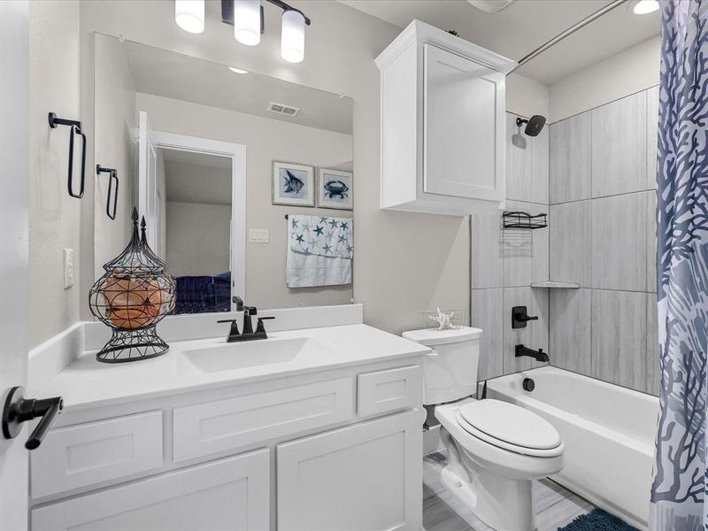 Full bathroom with vanity, toilet, and shower / tub combo with curtain