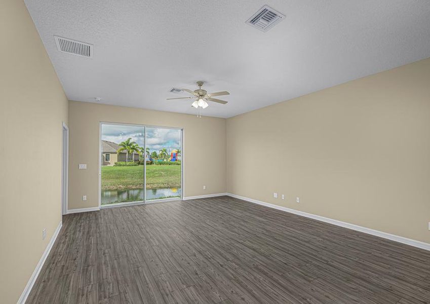 The family room has sliding glass doors that open into the backyard