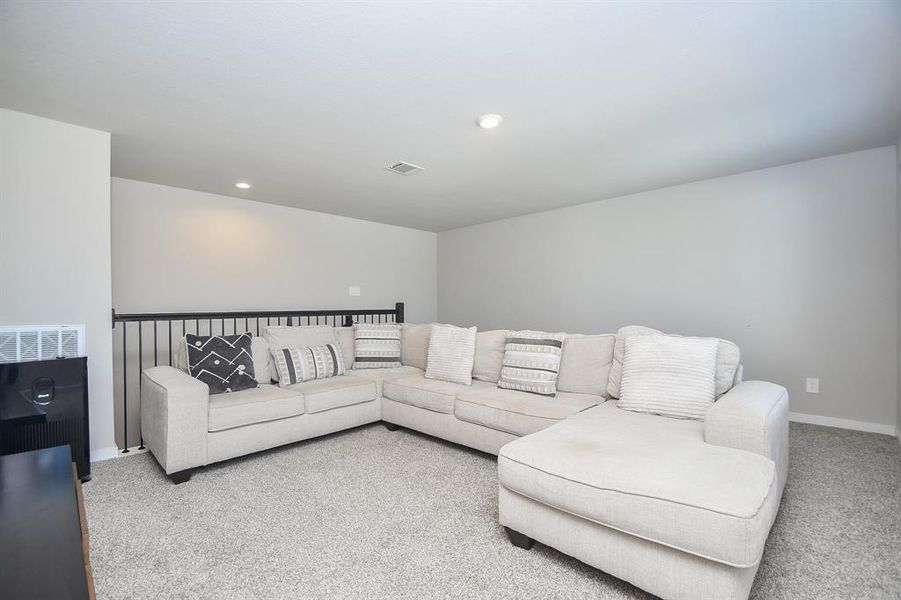 Upstairs living area with seating and open layout.