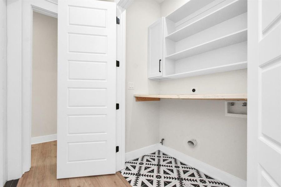 Effortless laundry with quartz counters, ample storage in this functional room.