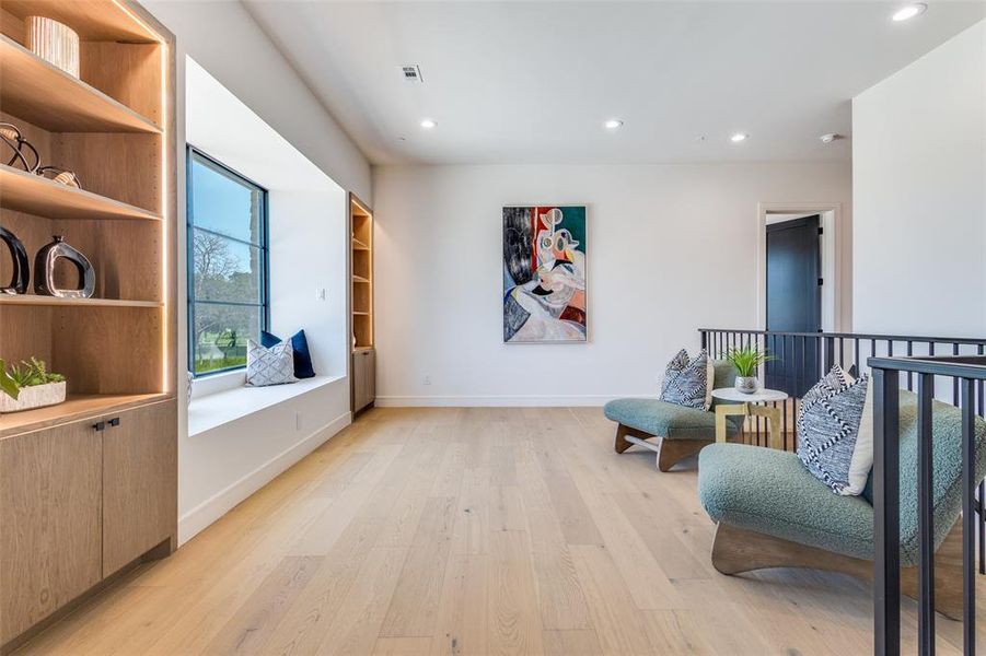 Sitting room with light hardwood / wood-style flooring