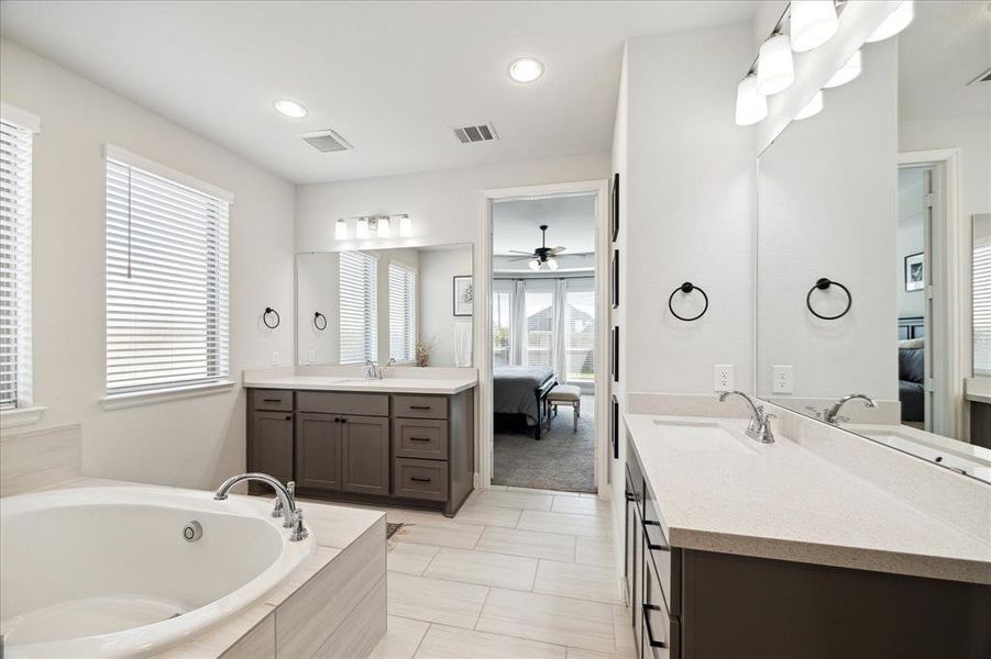 Primary bathroom with dual sinks, separate tub and shower and private water closet.  Huge walk-in closet.