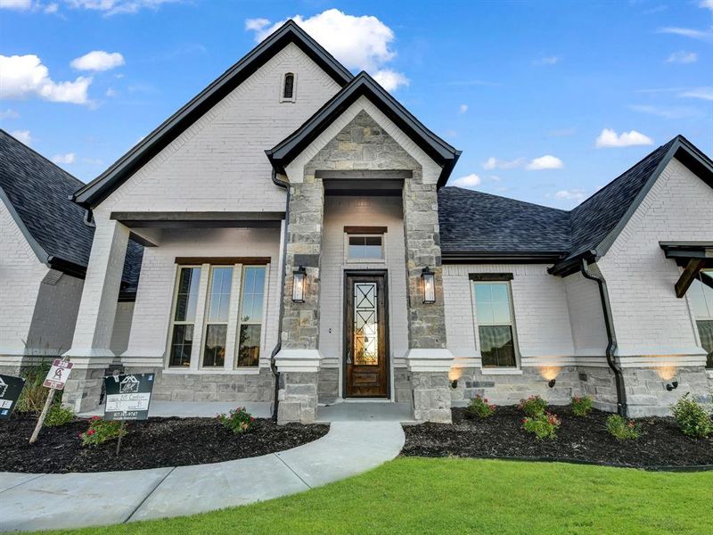 Doorway to property with a lawn