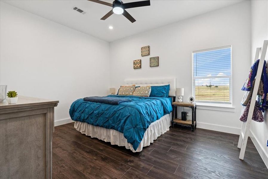 Bedroom with ceiling fan and dark hardwood / wood-style floors