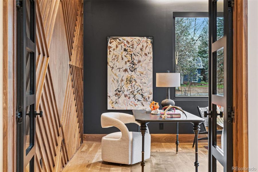 Main floor office with exquisite walnut wall that exudes timeless elegance and warmth.