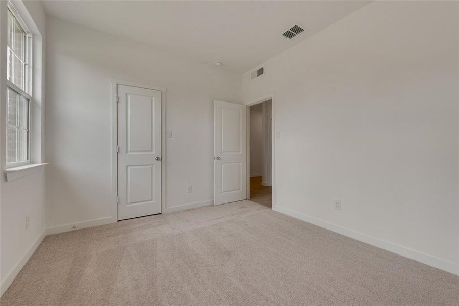 Unfurnished bedroom featuring light carpet