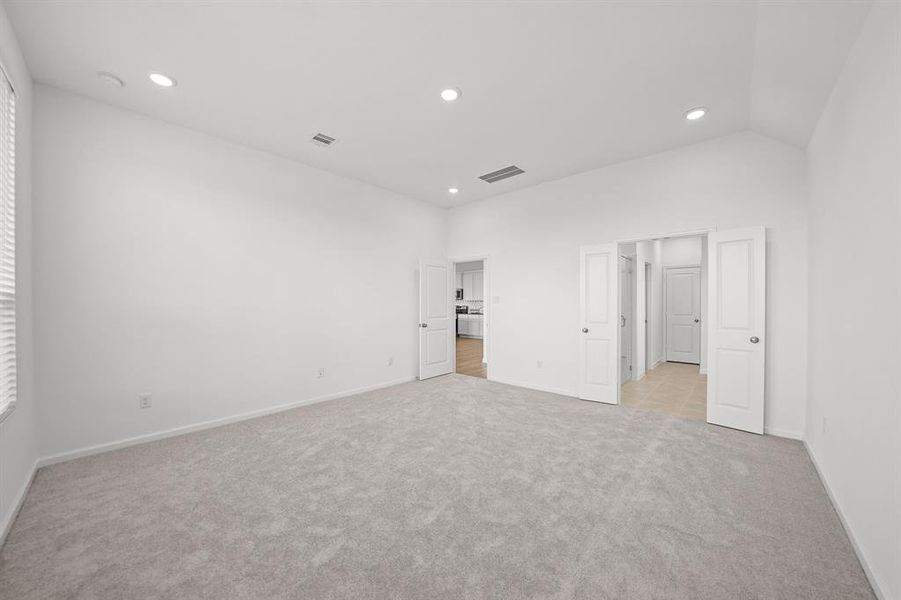 Large spacious Primary/Master Bedroom has French doors going to the bathroom. Recessed Lighting and carpet