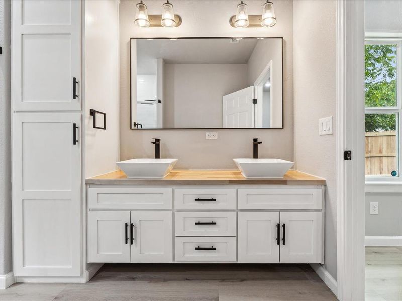 Bathroom featuring hardwood / wood-style flooring and vanity