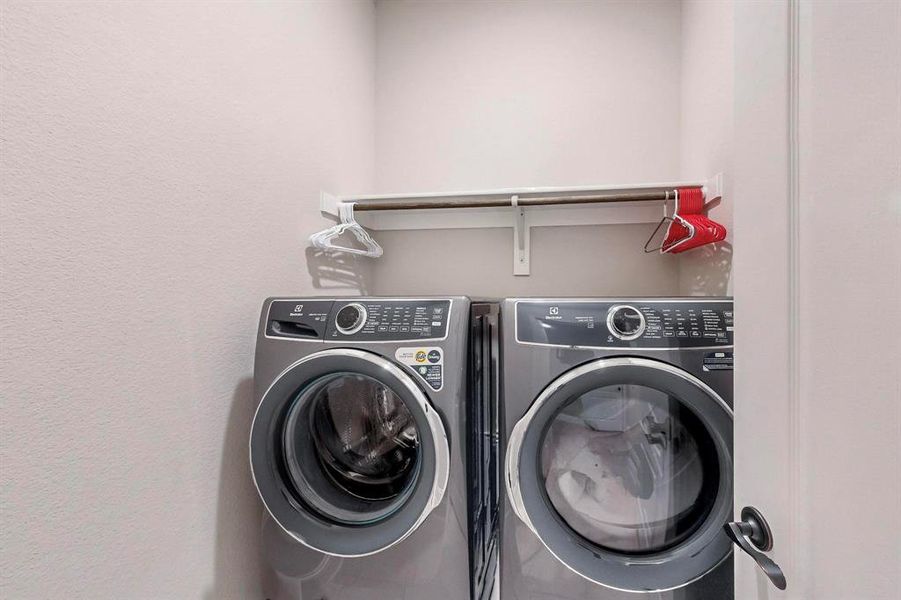 Washroom with washing machine and clothes dryer