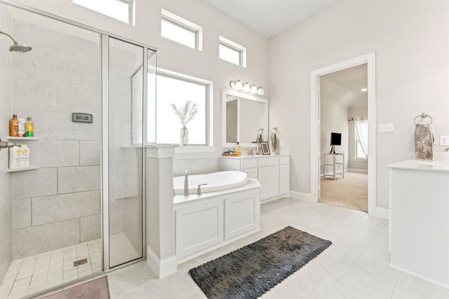 Bathroom with plus walk in shower, tile floors, and large vanity