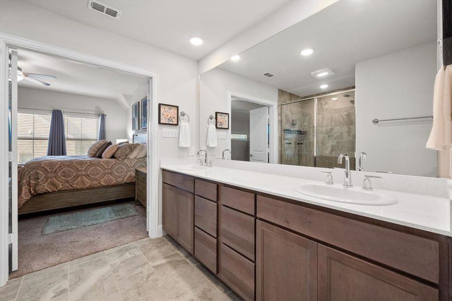 Bathroom featuring vanity, an enclosed shower, and ceiling fan