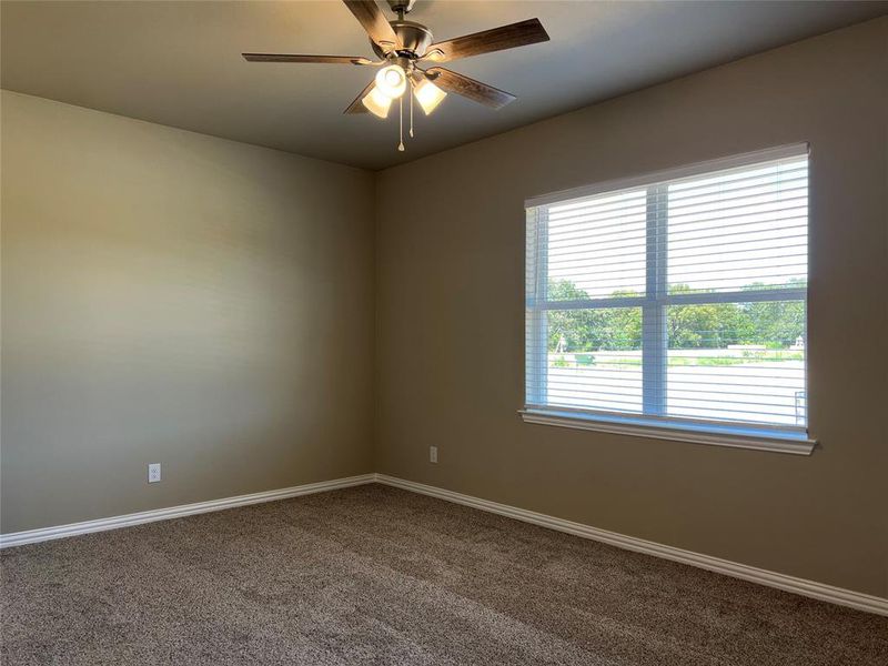 Empty room featuring carpet and ceiling fan