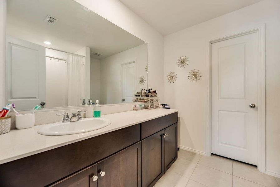 Bathroom with tile patterned floors and vanity